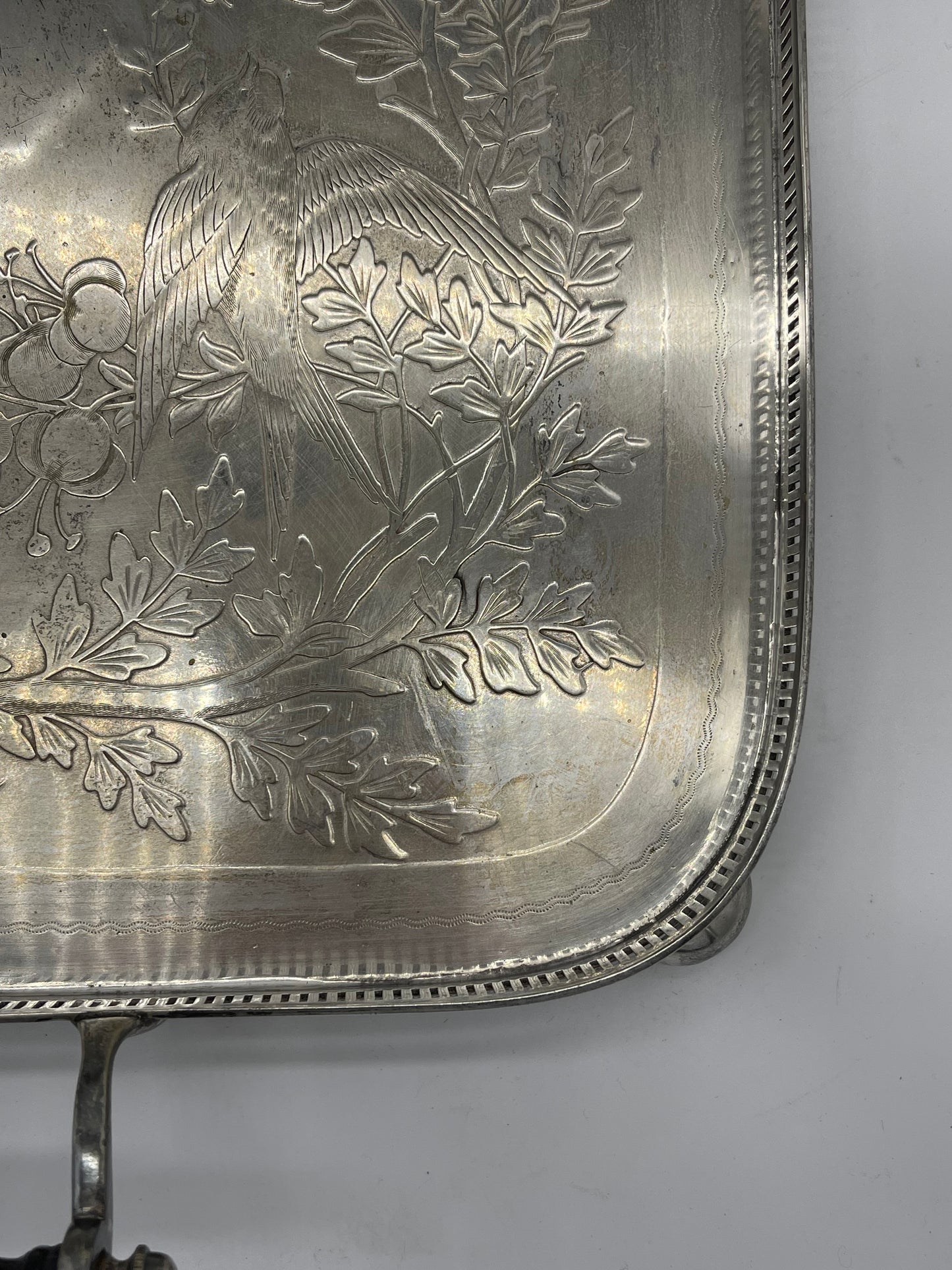 Exceptional footed silver tray with wooden serving handles and bird and floral engraving scene