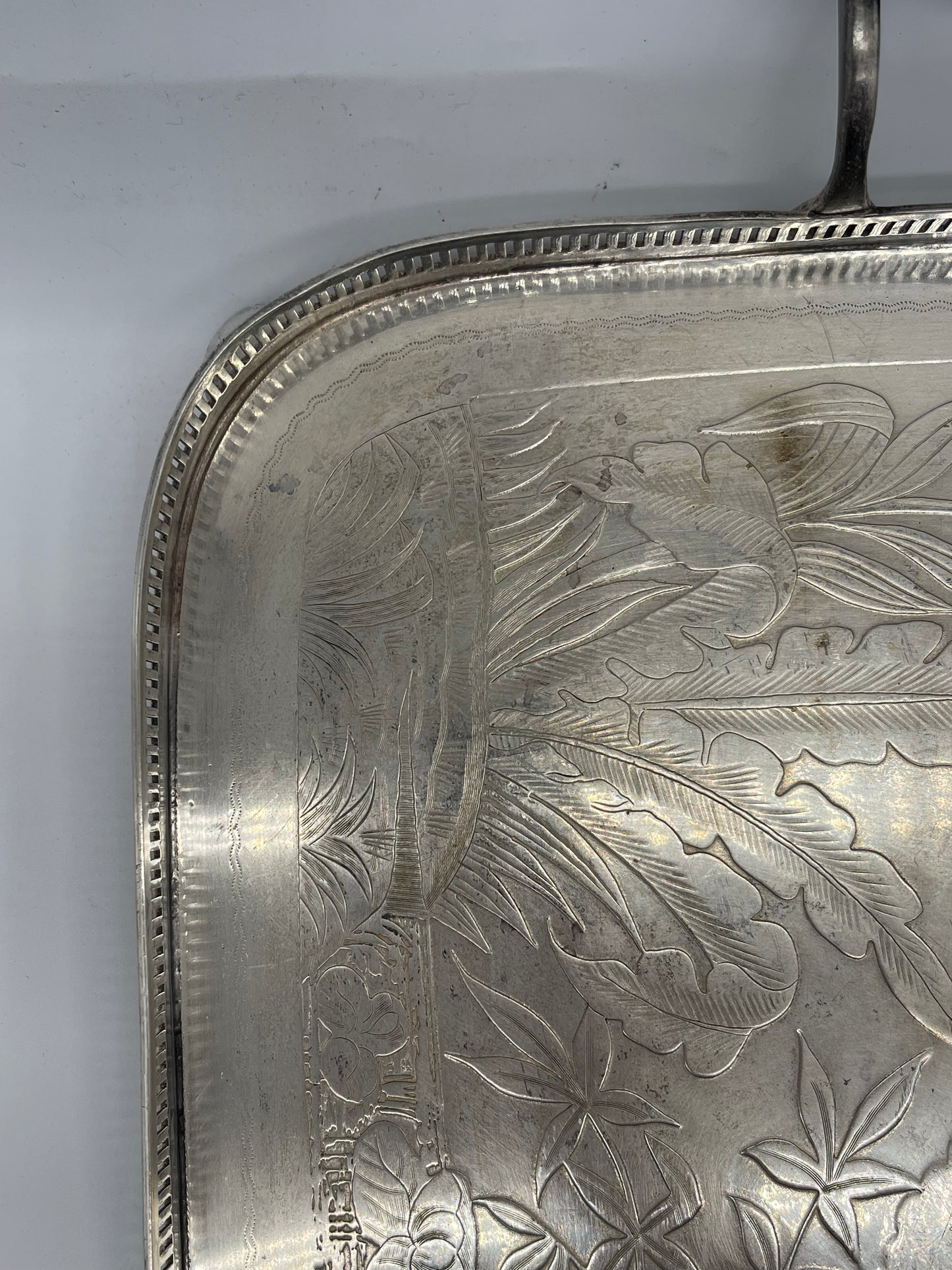 Exceptional footed silver tray with wooden serving handles and bird and floral engraving scene