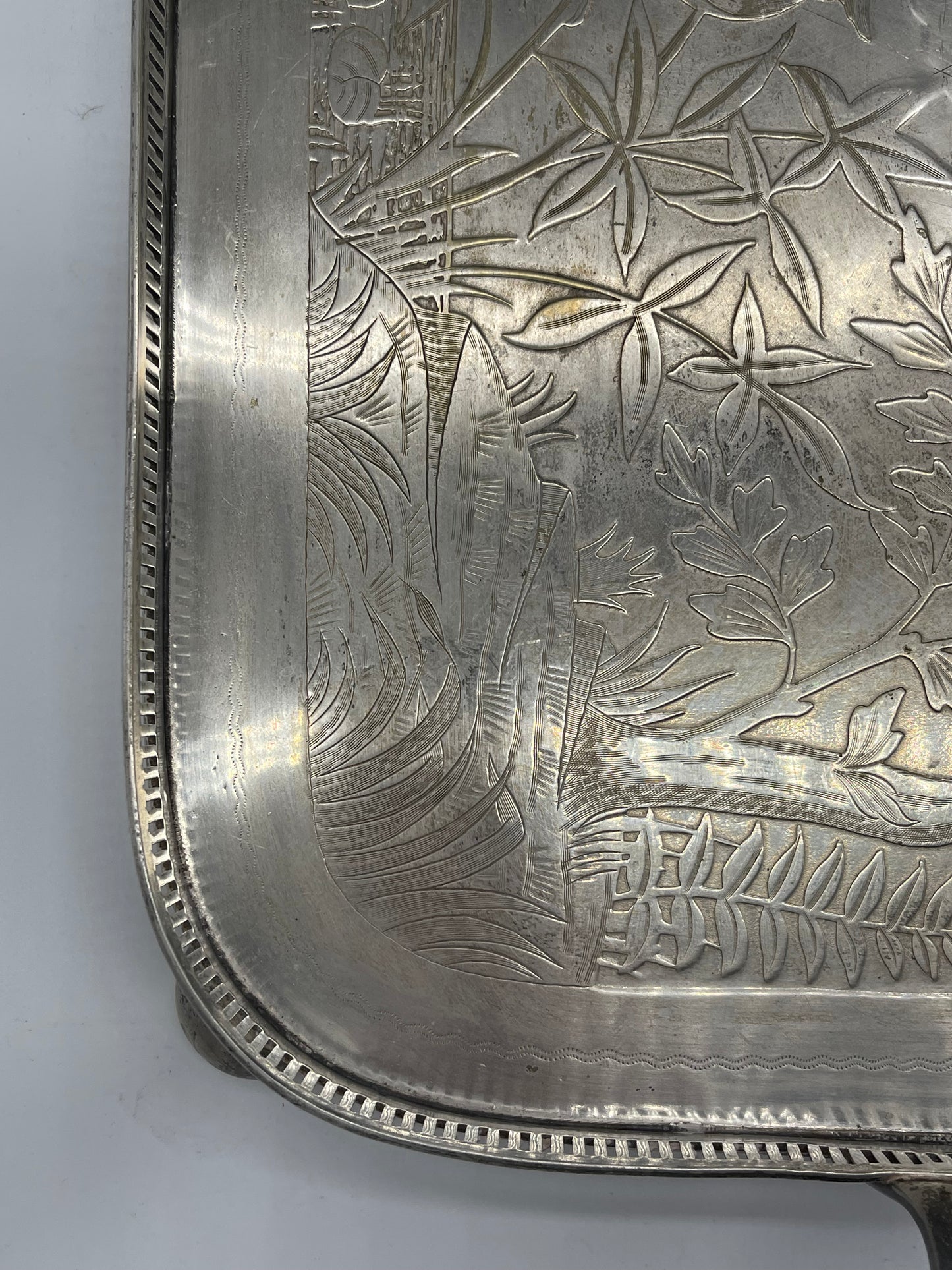 Exceptional footed silver tray with wooden serving handles and bird and floral engraving scene