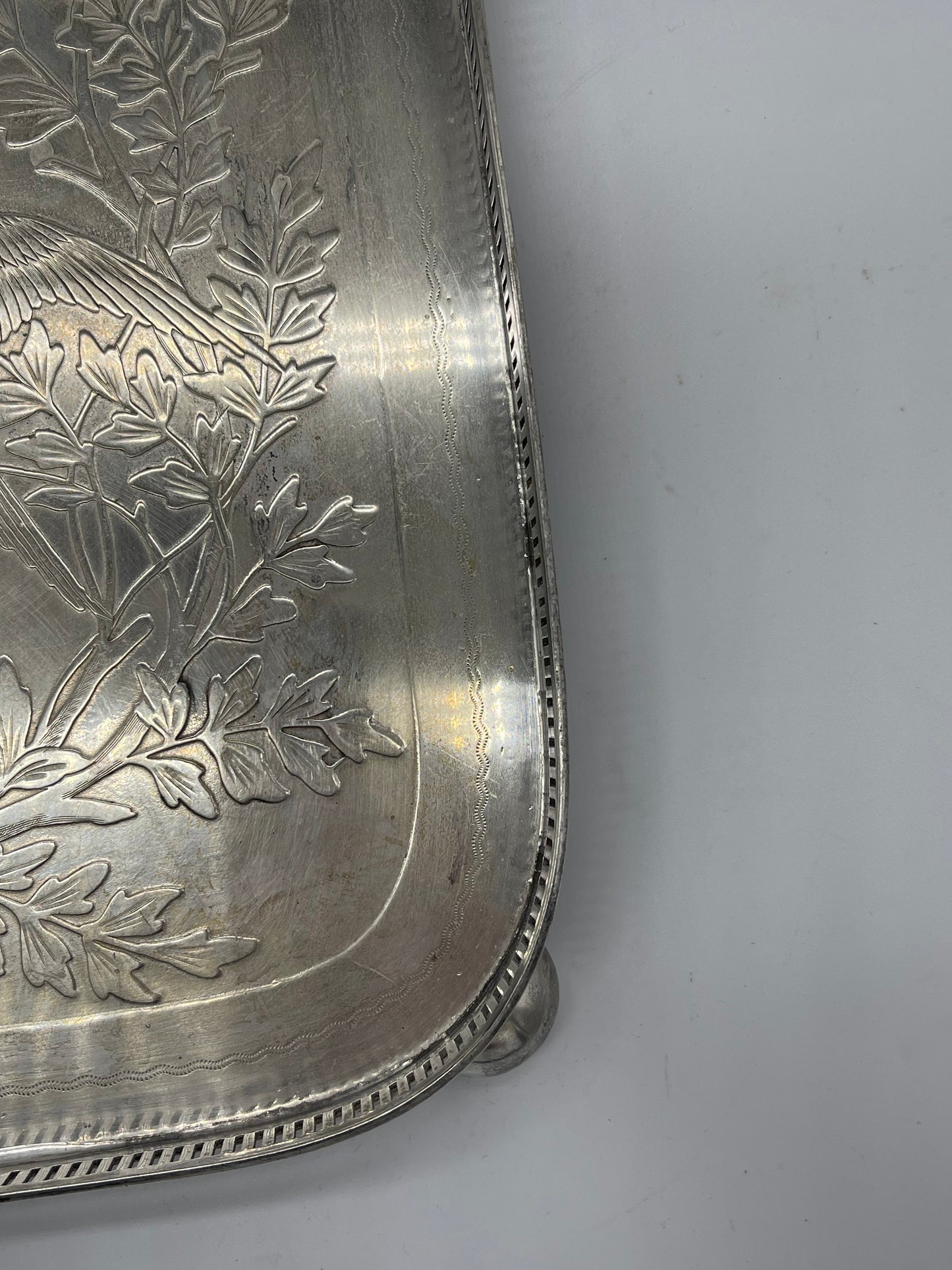 Exceptional footed silver tray with wooden serving handles and bird and floral engraving scene