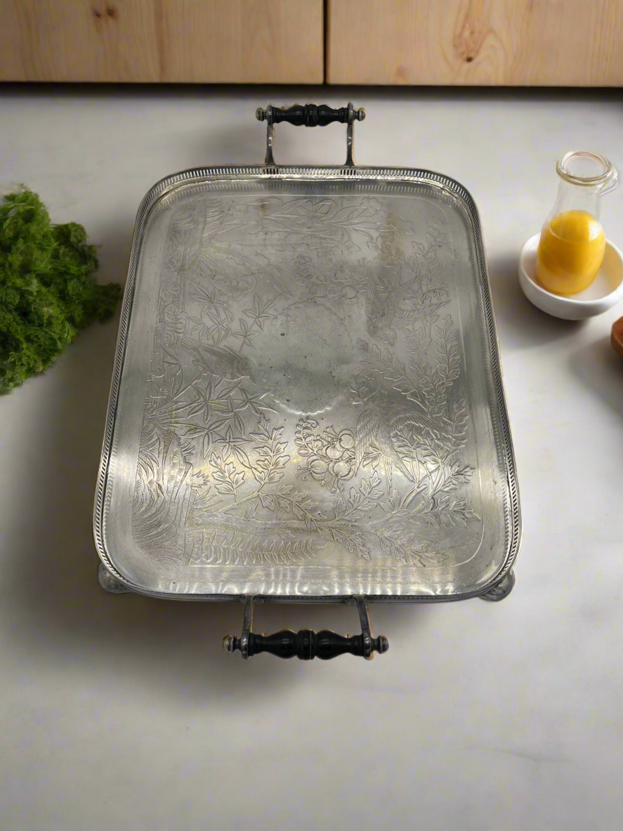 Exceptional footed silver tray with wooden serving handles and bird and floral engraving scene