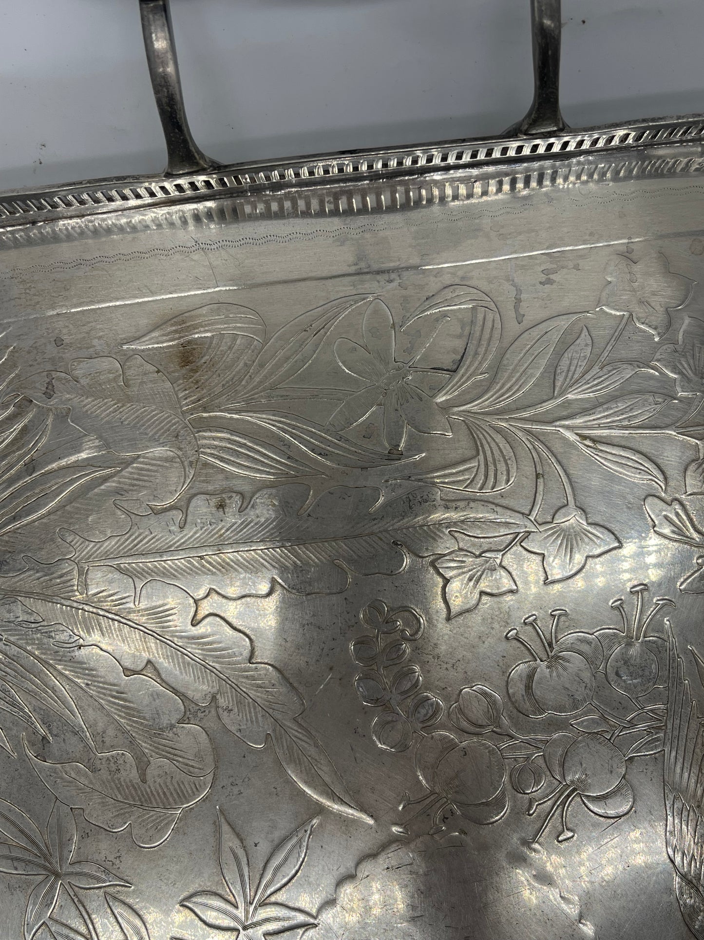 Exceptional footed silver tray with wooden serving handles and bird and floral engraving scene