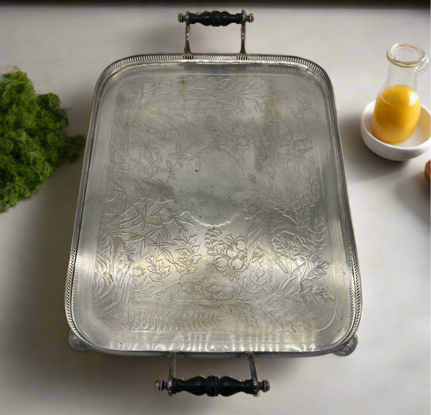 Exceptional footed silver tray with wooden serving handles and bird and floral engraving scene